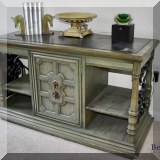 F45. Green console table with wrought metal scrollwork and faux stone top. 28.5”h x 48”w x 20.5”d